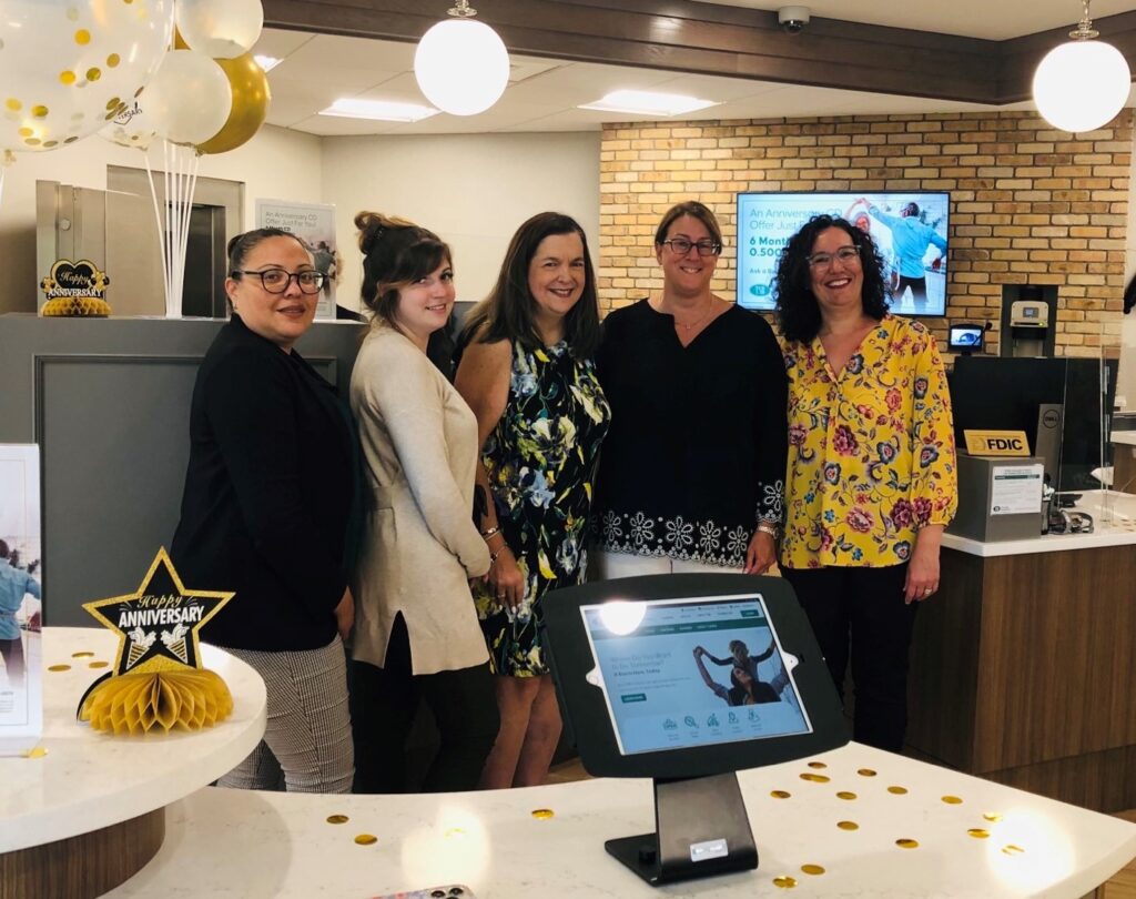 Bristol team poses in branch with balloons